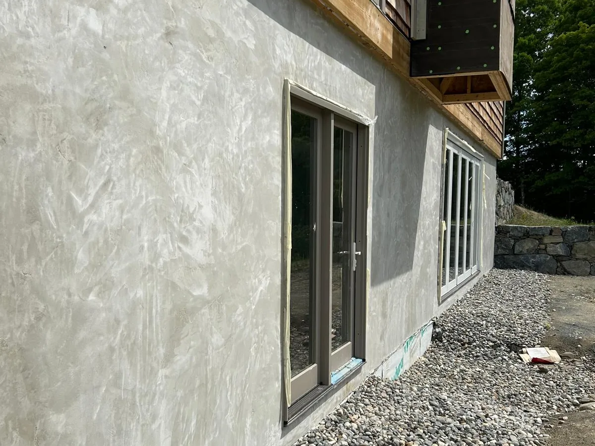 Long exterior elevation with stucco applied below the shingle line