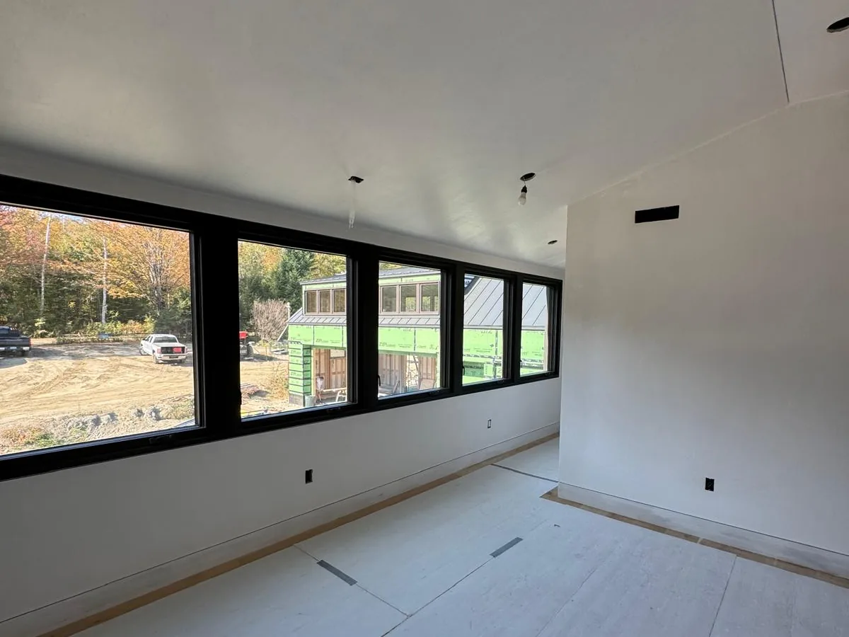 Modern finished room with a long window band and smooth plaster walls