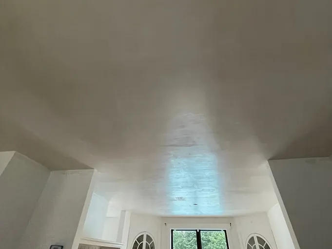 Smooth plaster over a curved ceiling above a bay window