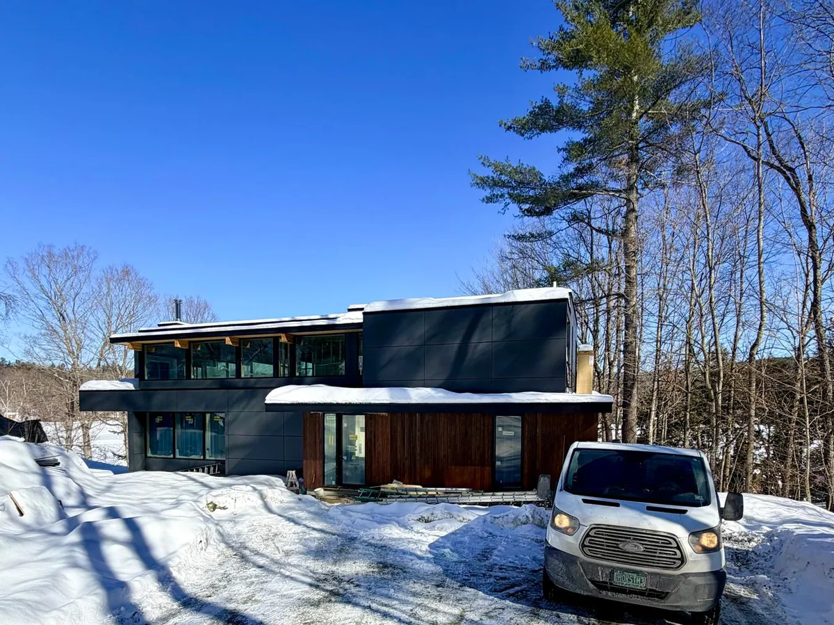 Horsth Plastering van at a modern home site in deep winter snow