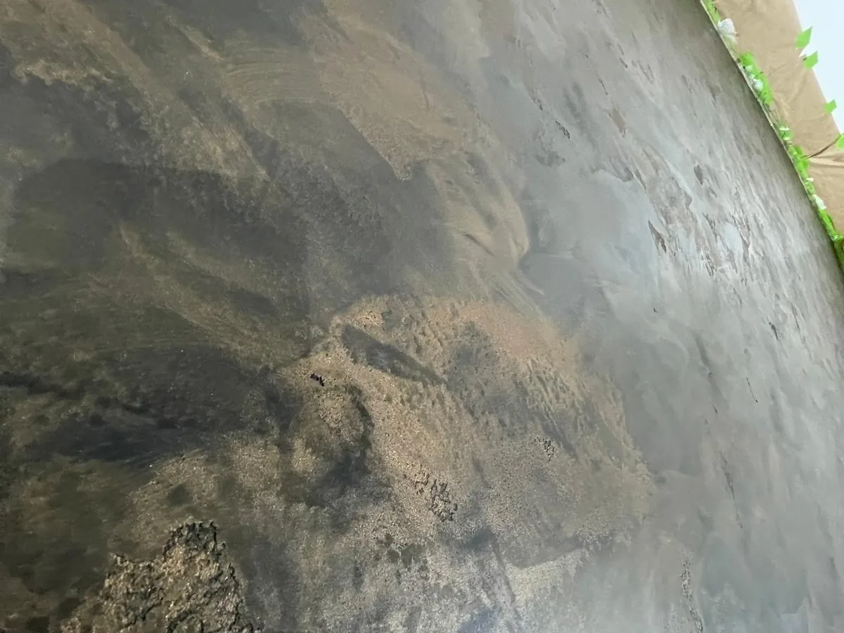 Close view of an oxidised effect plaster wall with metallic movement through the surface